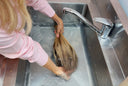 Human hair wig being cared for to protect softness and lifespan