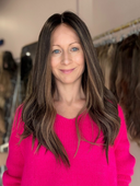 woman wearing a long brown human hair wig 