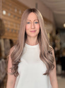 woman wearing a long beige blonde human hair wig 